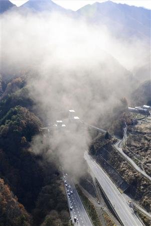 Smoke is seen from the Sasago Tunnel on the Chuo Expressway in Koshu, Yamanashi prefecture, in this Kyodo handout photo, December 2, 2012. REUTERS/Kyodo