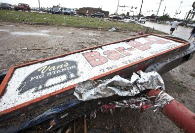 A sign for a local restaurant lies on the ground after a huge tornado struck Moore, Oklahoma, near Oklahoma City, May 20, 2013. A massive tornado tore through the Oklahoma City suburb of Moore on Monday, killing at least 51 people as winds of up to 200 miles per hour (320 kph) flattened entire tracts of homes, two schools and a hospital, leaving a wake of tangled wreckage. REUTERS/Richard Rowe (UNITED STATES – Tags: DISASTER ENVIRONMENT)
