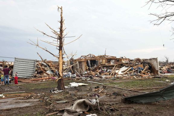 Stripped trees and destroyed houses remain after a huge tornado struck Moore, Oklahoma, near Oklahoma City, May 20, 2013. REUTERS/Richard Rowe