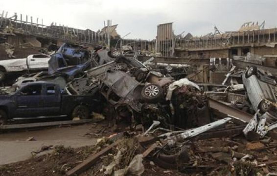 Overturned cars are seen after a huge tornado touched down in the town of Moore, near Oklahoma City, Oklahoma May 20, 2013. REUTERS/Richard Rowe