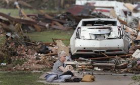 Kay James holds her cat as she sits in her driveway after her home was destroyed by the tornado that hit the area on Monday, May 20, 2013 in Oklahoma City, Okla. (AP Photo/The Oklahoman, Chris Landsberger)