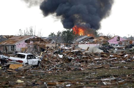 A fire burns in the Tower Plaza Addition in Moore, Okla., following a tornado Monday, May 20, 2013. A tornado as much as a mile wide with winds up to 200 mph roared through the Oklahoma City suburbs Monday, flattening entire neighborhoods, setting buildings on fire and landing a direct blow on an elementary school. (AP Photo Sue Ogrocki