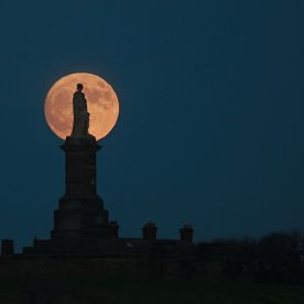 The ‘Supermoon’ silhouettes the statue to Admiral Lord Collingwood which overlooks the entrance to the river Tyne at Tynemouth, Tyne & Wear. (SWNS)