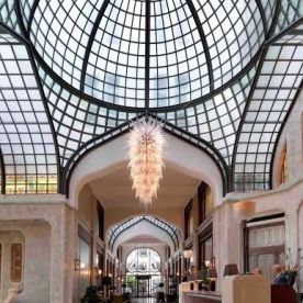 Guests of this Art Nouveau treasure, located on the banks of the Danube River, are greeted by a sprawling white-and-aqua-blue glass atrium in the hotel’s lobby. The glass ceiling, described by the hotel as “a true labor of love,” was designed to enclose what was originally a horse-and-carriage drop-off for the palace.