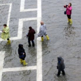 People walk through flood waters in St. Mark's Square on Tuesday.Luca Bruno/AP